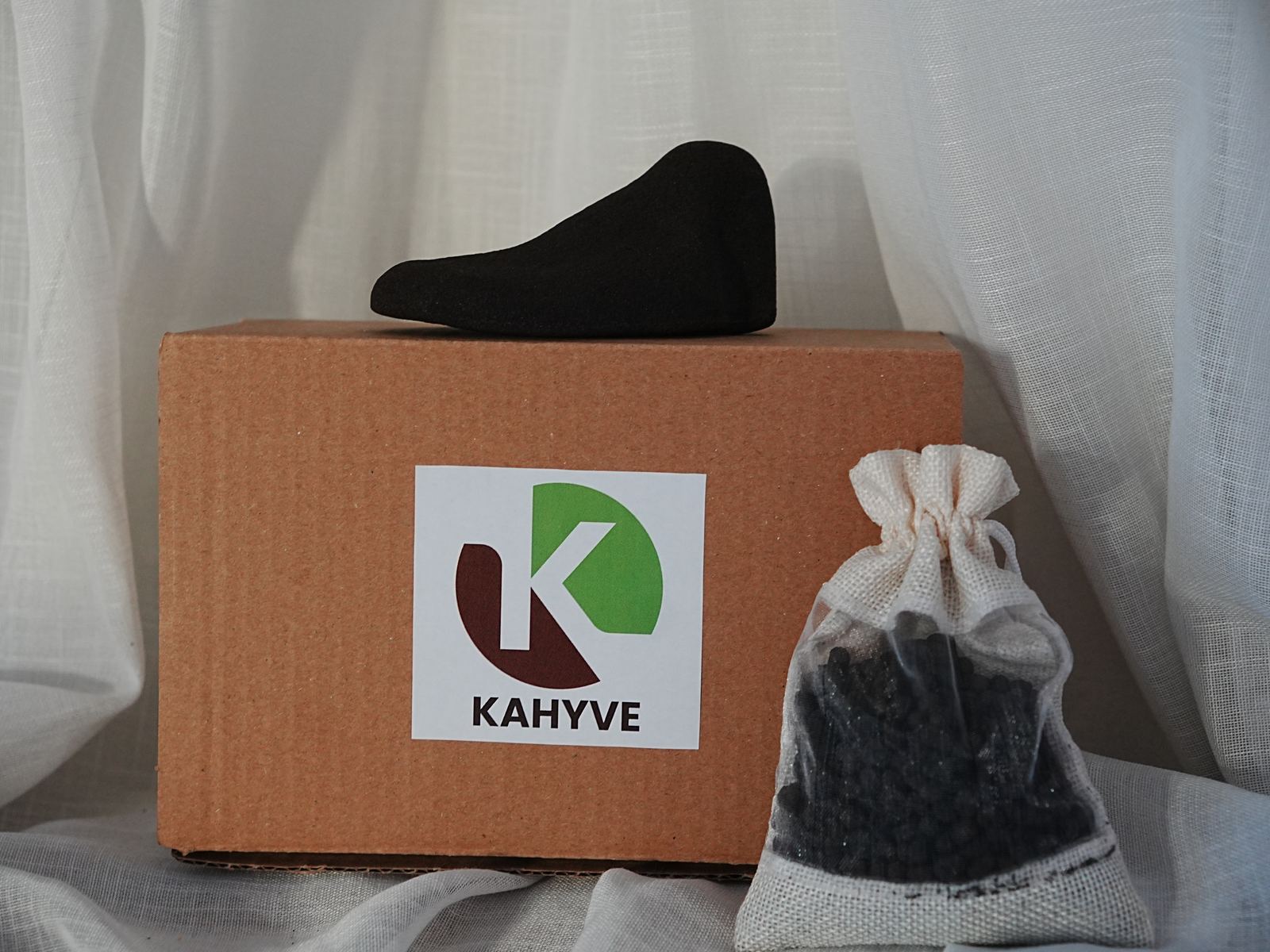 Kahyve box with a shoe tree on top and a bag of pellets beside it